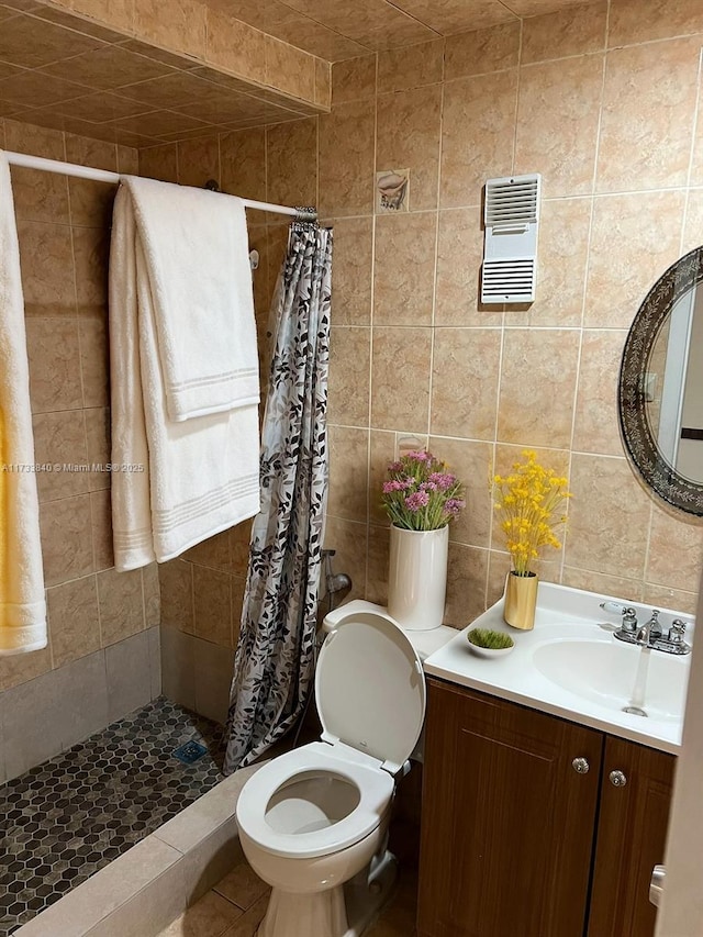 bathroom with a shower with curtain, vanity, tile walls, and toilet