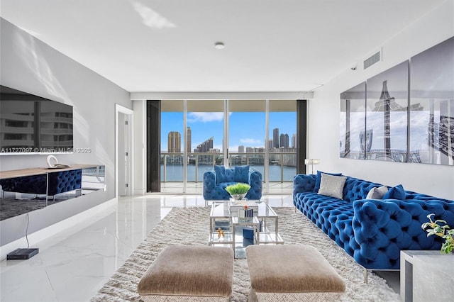 living room featuring expansive windows and a water view