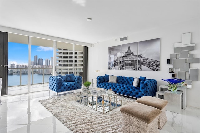 living room with a water view and floor to ceiling windows