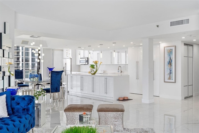 living room with sink and a notable chandelier