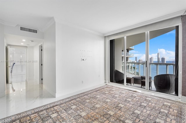 empty room featuring crown molding and a water view