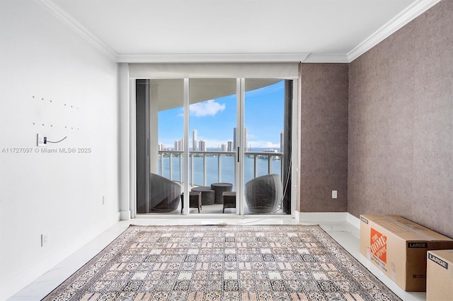 spare room with ornamental molding, a water view, and floor to ceiling windows