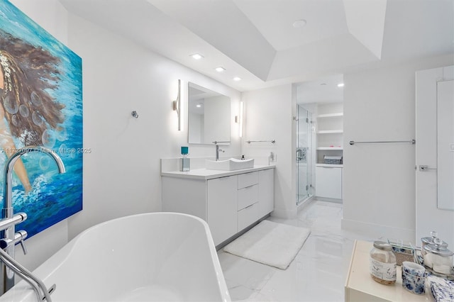 bathroom featuring vanity, a tray ceiling, and plus walk in shower