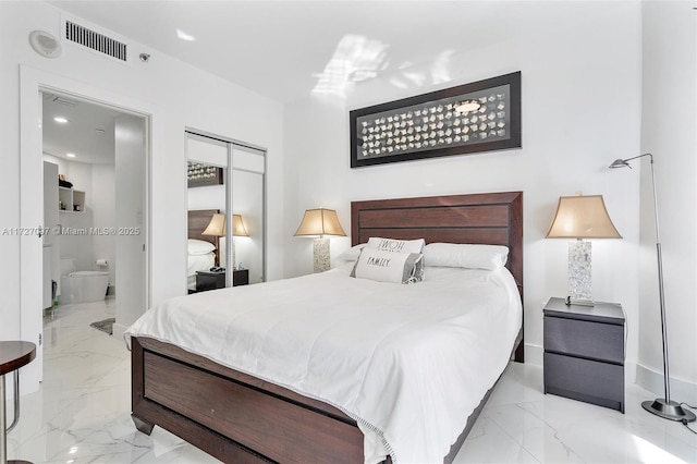 bedroom with ensuite bath and a closet