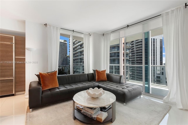 living room with a wealth of natural light and light tile patterned flooring