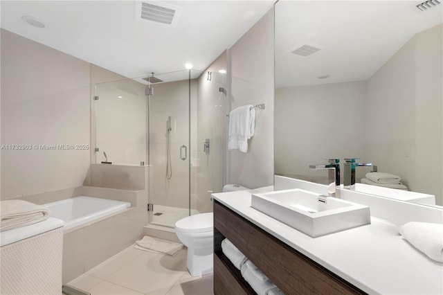 full bathroom featuring toilet, vanity, shower with separate bathtub, and tile patterned flooring