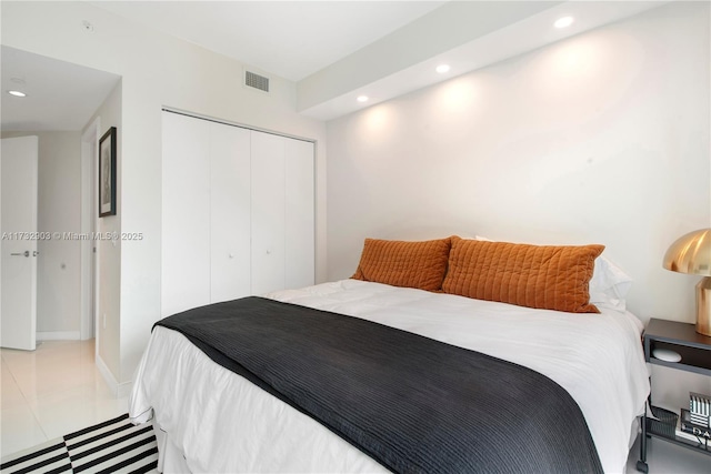 tiled bedroom featuring a closet