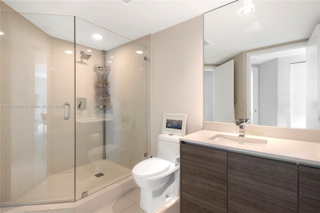 bathroom featuring vanity, tile patterned floors, a shower with door, and toilet