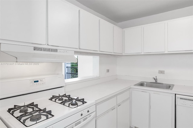 kitchen featuring white appliances, sink, and white cabinets