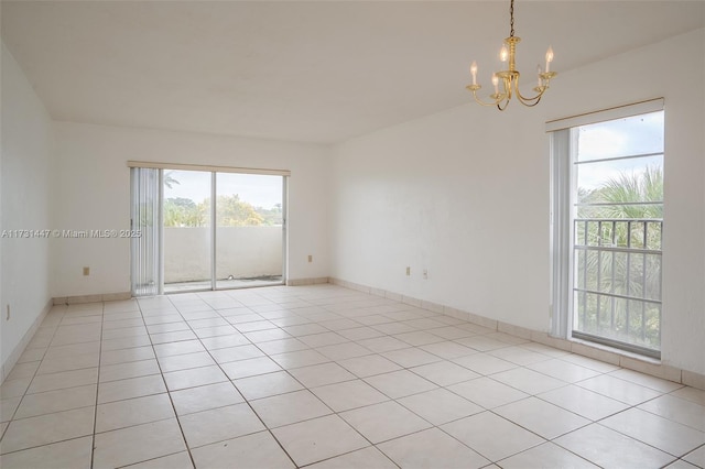 tiled empty room with a chandelier