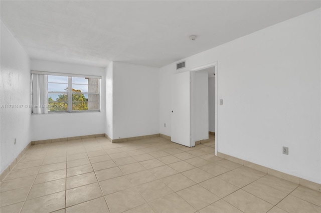 unfurnished room with light tile patterned floors