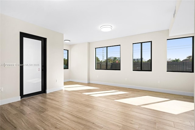 empty room with light hardwood / wood-style flooring