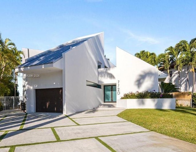 contemporary home with a garage and a front lawn