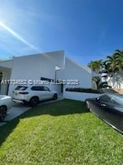 contemporary home with a garage and a front yard