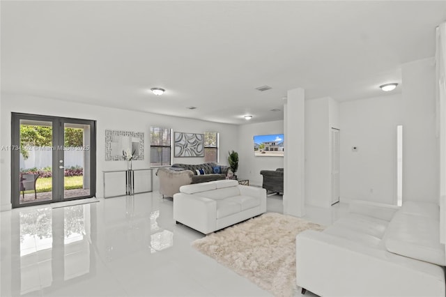 living room with french doors and light tile patterned flooring