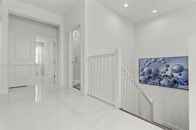 hall featuring light tile patterned flooring