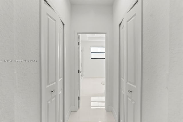 corridor featuring light tile patterned flooring