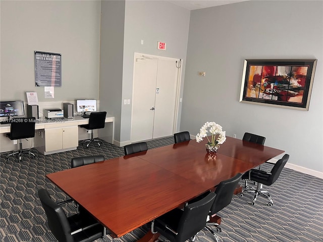 office area with dark colored carpet and built in desk