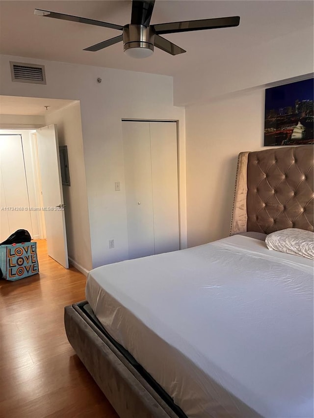 bedroom featuring wood-type flooring, a closet, and ceiling fan