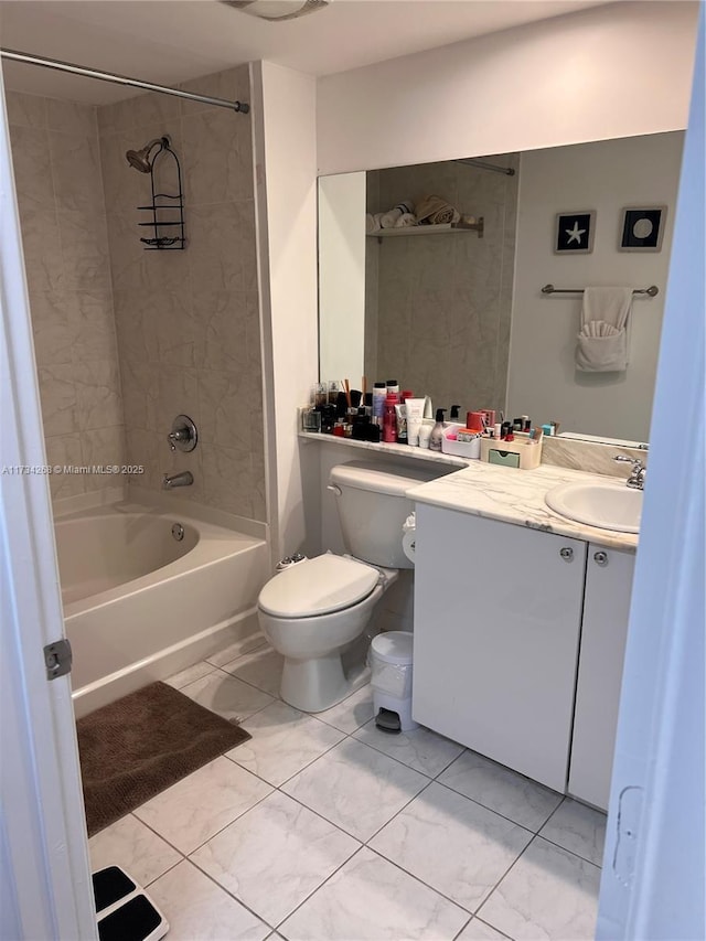 full bathroom with tiled shower / bath, vanity, and toilet