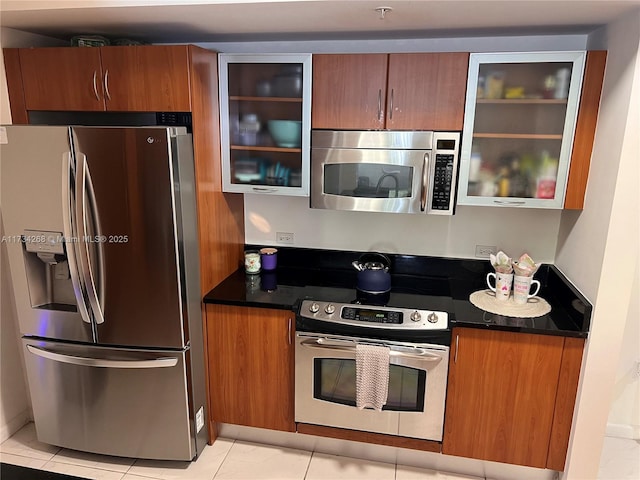 kitchen featuring light tile patterned flooring and appliances with stainless steel finishes