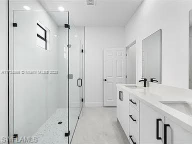 bathroom featuring vanity, concrete flooring, and walk in shower