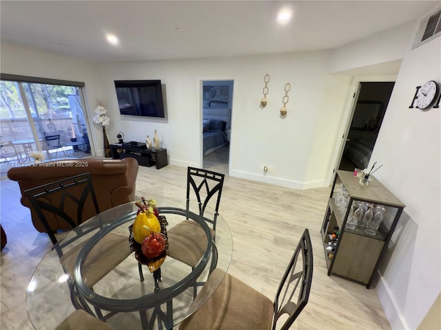 dining area featuring light wood-type flooring