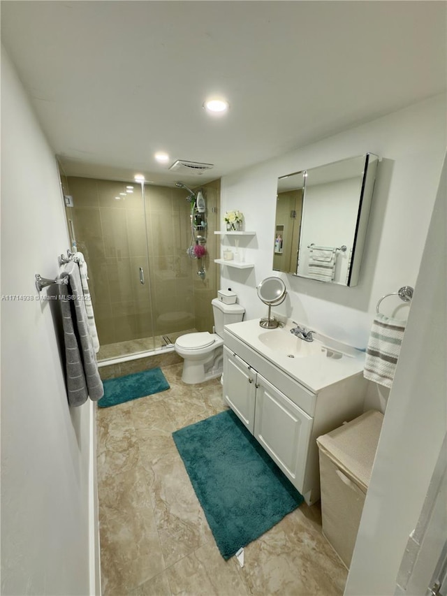 bathroom with vanity, toilet, and walk in shower