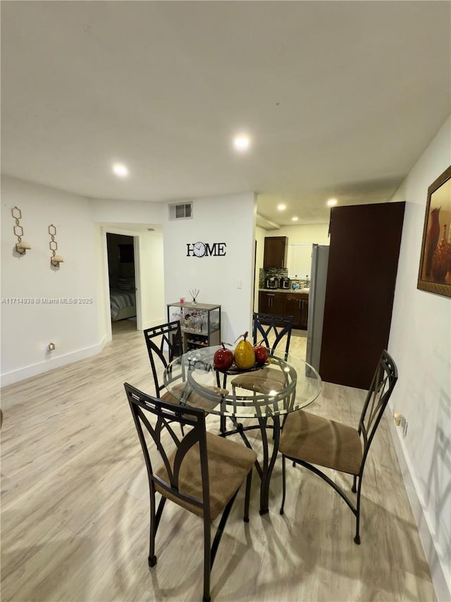 dining space featuring light hardwood / wood-style flooring