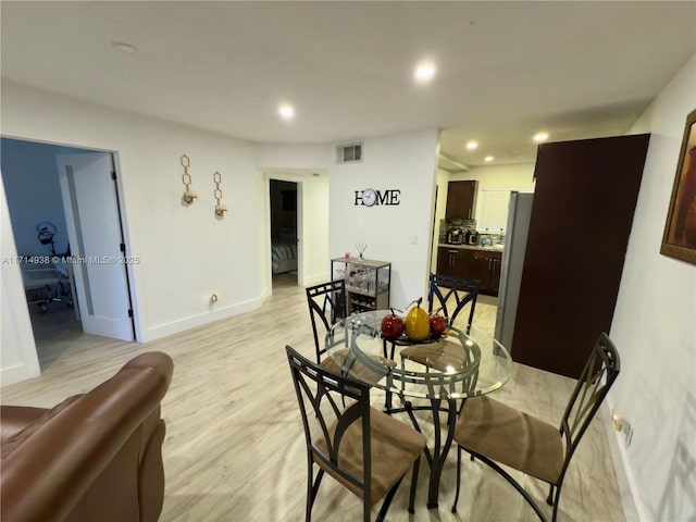 dining space featuring light wood-type flooring