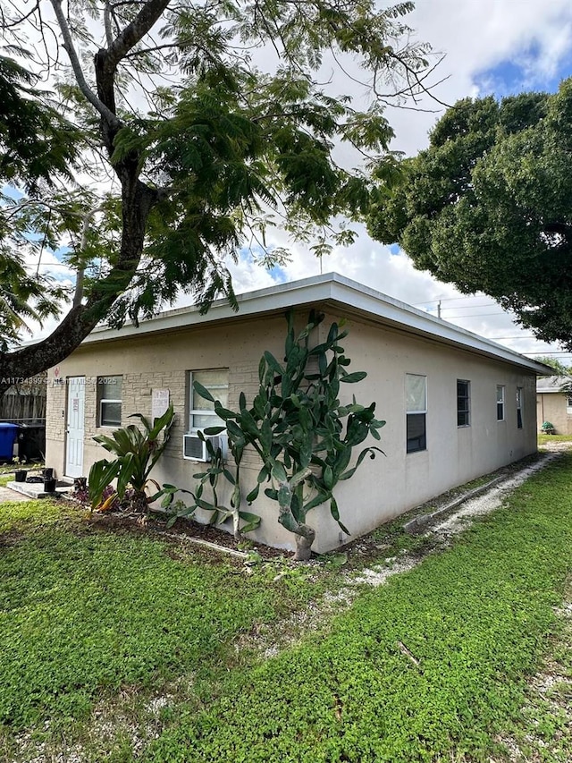 view of side of home featuring a lawn