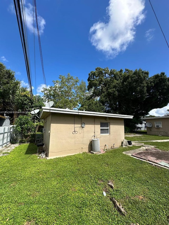 rear view of property featuring a lawn