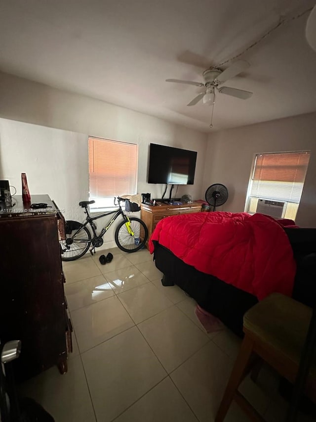 tiled bedroom featuring cooling unit and ceiling fan