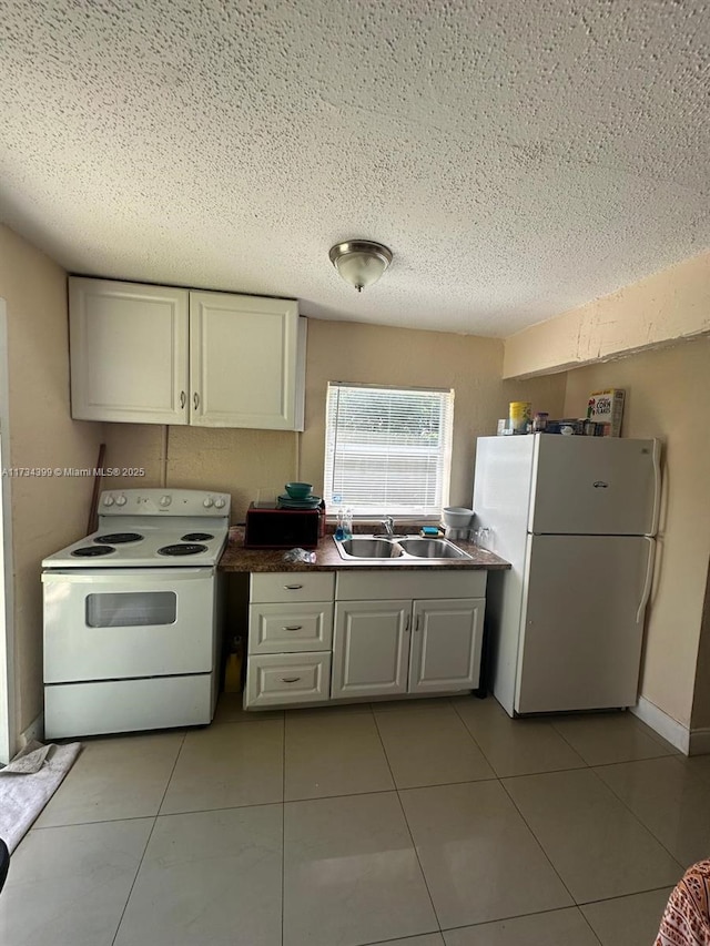 kitchen with white cabinetry, white appliances, sink, and light tile patterned floors