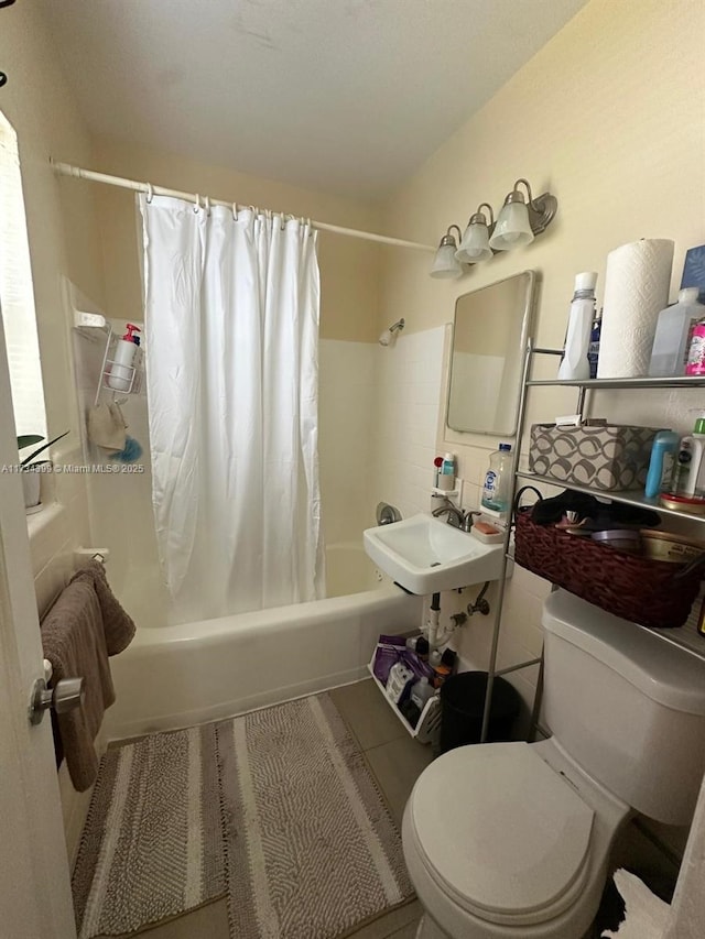 full bathroom featuring shower / tub combo, sink, tile patterned flooring, and toilet