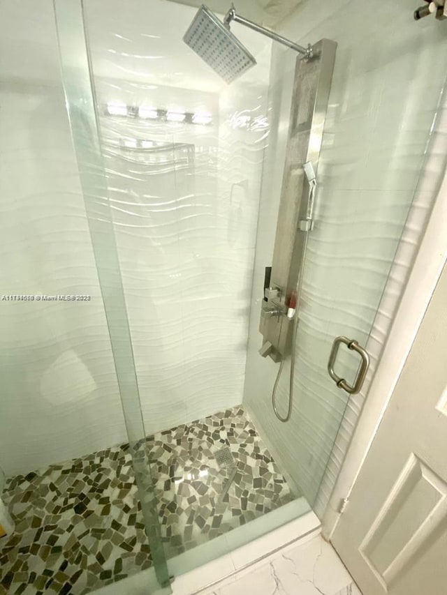 bathroom with a shower with shower door