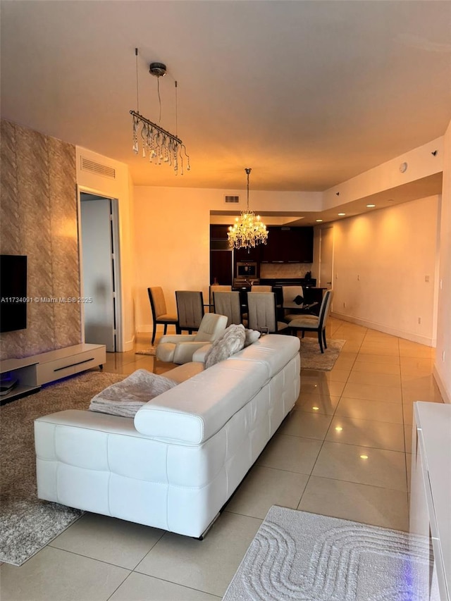 living room featuring light tile patterned floors and a notable chandelier