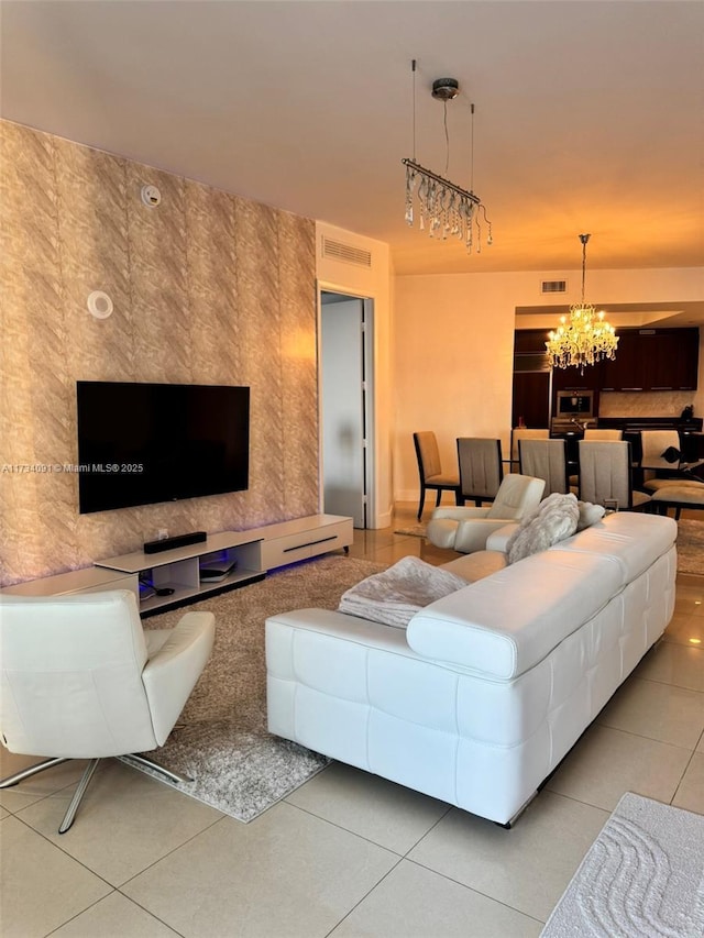 tiled living room featuring an inviting chandelier