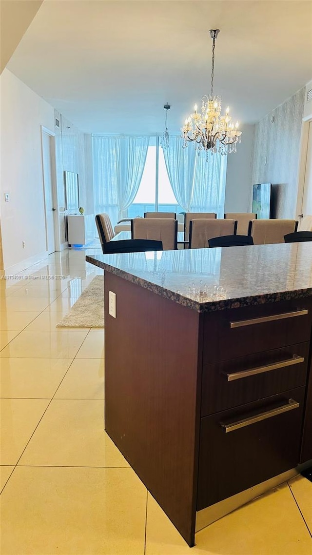 kitchen featuring hanging light fixtures, a notable chandelier, and light tile patterned flooring