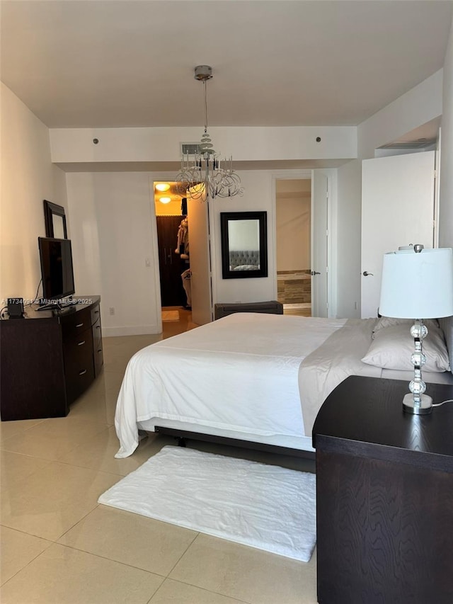 bedroom featuring an inviting chandelier and light tile patterned flooring