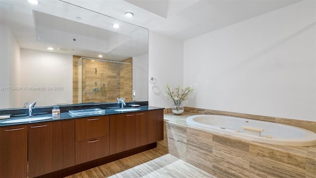 bathroom with vanity and separate shower and tub