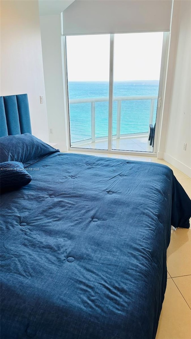 tiled bedroom with a water view