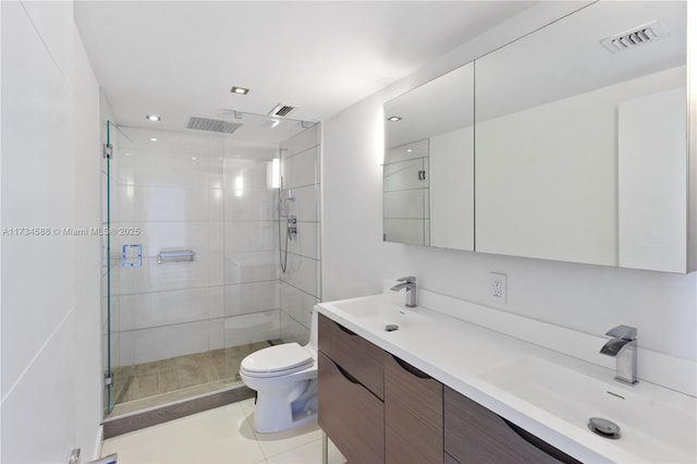 bathroom with vanity, toilet, an enclosed shower, and tile patterned flooring