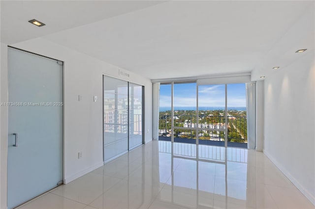 tiled empty room with floor to ceiling windows