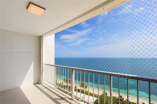 balcony with a water view and a beach view