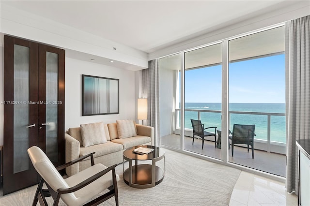 living room with a wall of windows and a water view