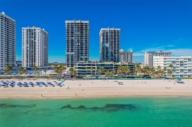 bird's eye view with a water view and a beach view