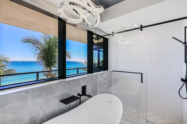 bathroom featuring a water view and shower with separate bathtub