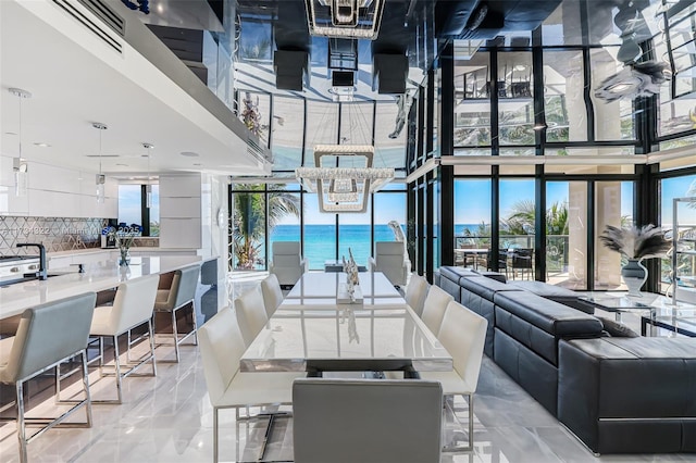 dining room featuring expansive windows, a healthy amount of sunlight, and a chandelier