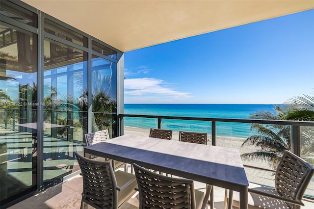 balcony with a water view and a beach view